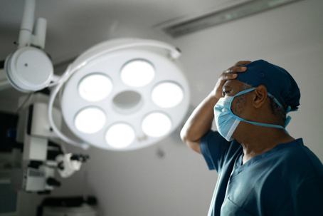 Worried healthcare male nurse at operating room in hospital